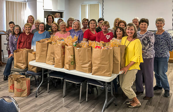 Group Photo of women with bagged Thanksgiving groceries