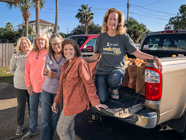 Women loading Thanksgiving groceries into a truck