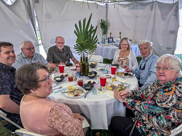 Group enjoys lunch together outside