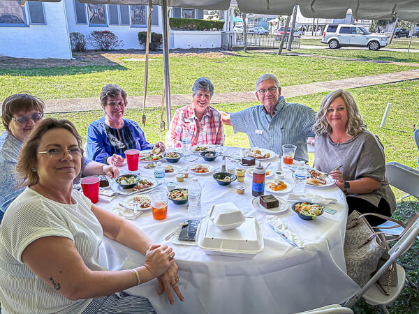 Group enjoys lunch together outside