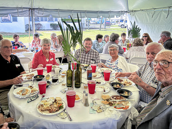 Group enjoys lunch together outside