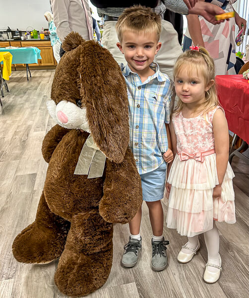 Children on Easter with a large stuffed animal