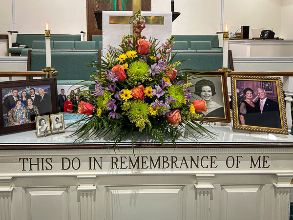 Beautiful photographs and flowers on alter table at a memorial service