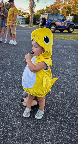 Small child outdoors enjoying Trunk or Treat 2023