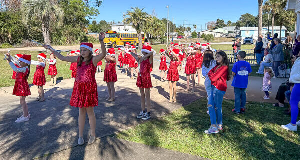 West Bay twirlers perform outside the church entrance.