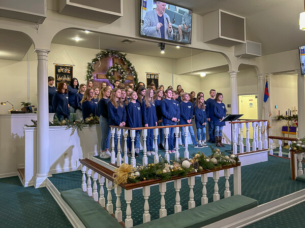 Bozeman student choir stands in front of the church.