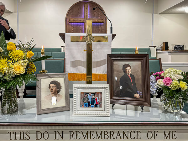 Photographs on altar table at Memorial Service