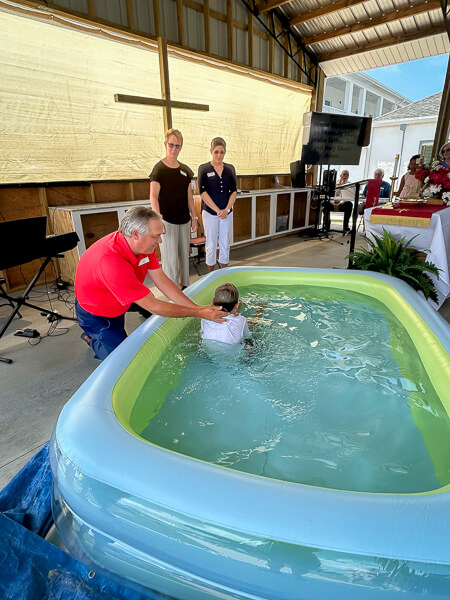 Young boy gets baptized by immersion