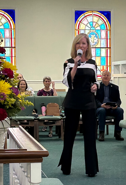 Neysa Wilkins sings during worship service.