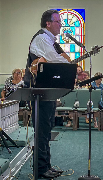 Bill Rader performs during worship service