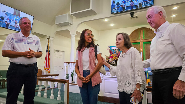 A woman is blessed during worship service.