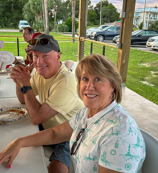 Couple at a table with winning smiles.