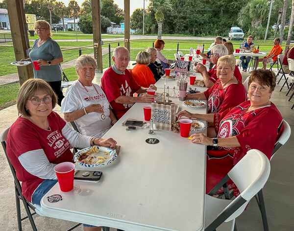 Alabama fans sit at table.