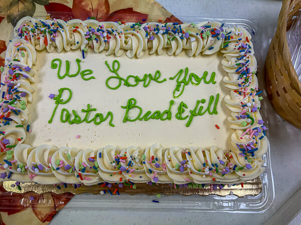 Cake that says We Love You Pastor Brad and Jill