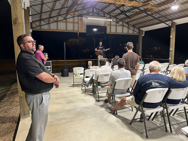 Man sings in pavilion after Thanksgiving dinner