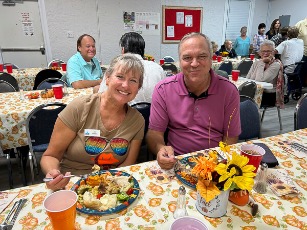 Man and woman happily eating church meal