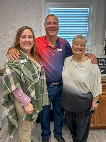 Pastor and two UWF women in Fellowship Hall