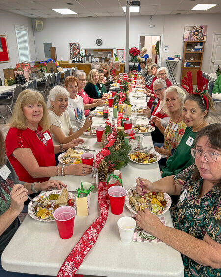 Large table of ladies eat in fellowship hall