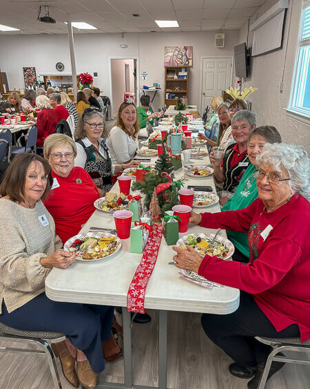 Large table of ladies eat in the fellowship hall