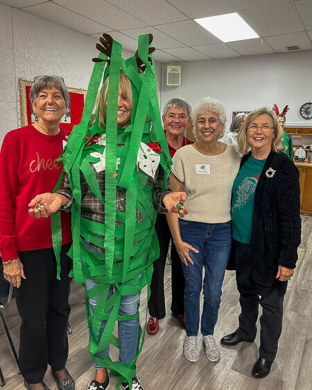 Small group of ladies stand and smile