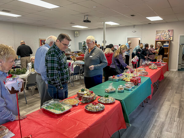 People looking at baked goods in Fellowship Hall