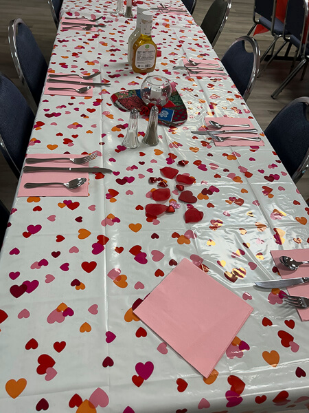 A long table decorated with Valentine hearts