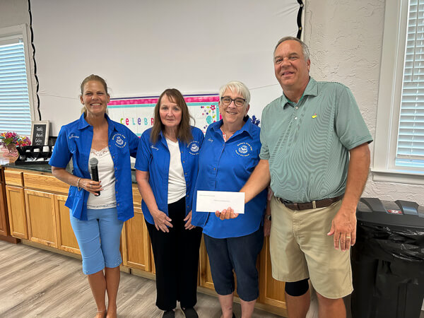 Pastor accepts donation from three Civic Club Members