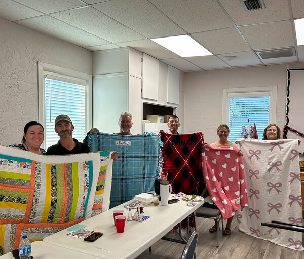 Six people receive quilts at Emmaus Walk Dinner