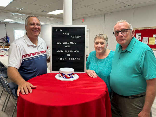 Pastor and a couple in the Fellowship Hall