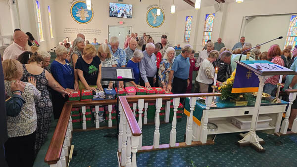 Congregation gathers to pray for the Operation Christmas child boxes