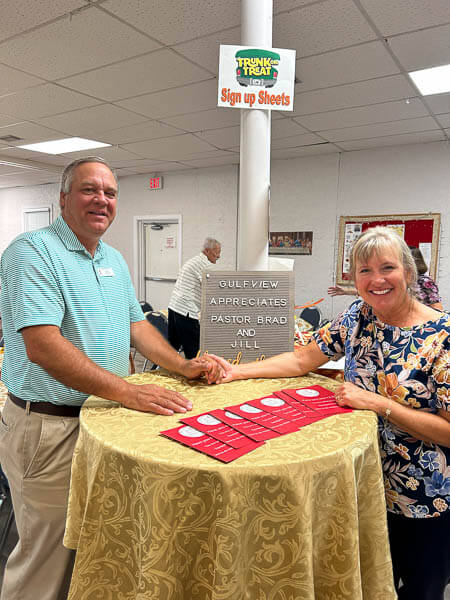 Pastor Brad and Jill in the Fellowship Hall with decorations
