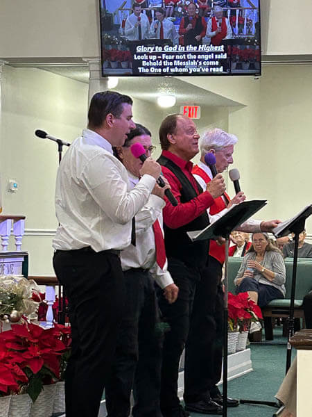 Four men sing during Advent Worship Service