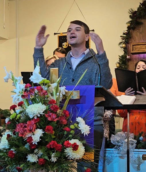 Man leads music during worship service.