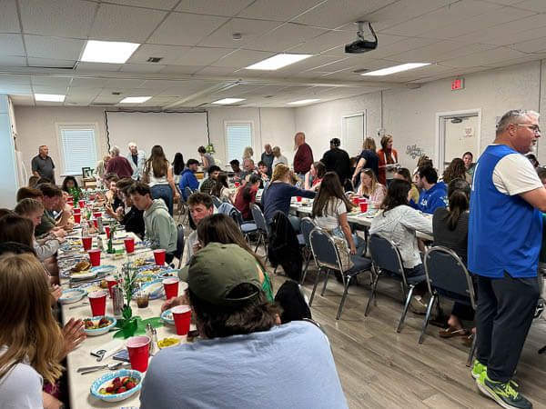 A crowd eats in the fellowship hall