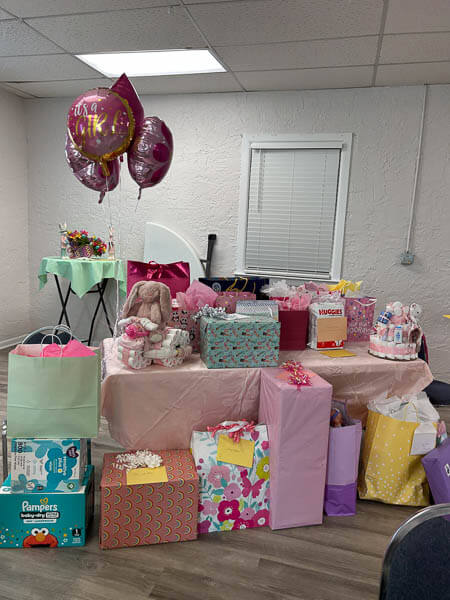 A table full of baby shower gifts