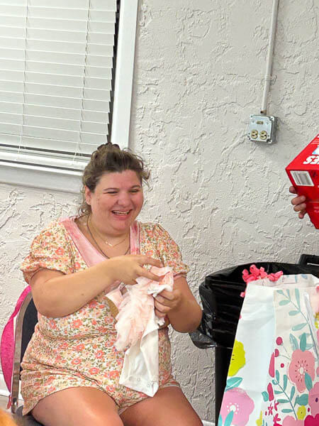 Woman happily opens gifts
