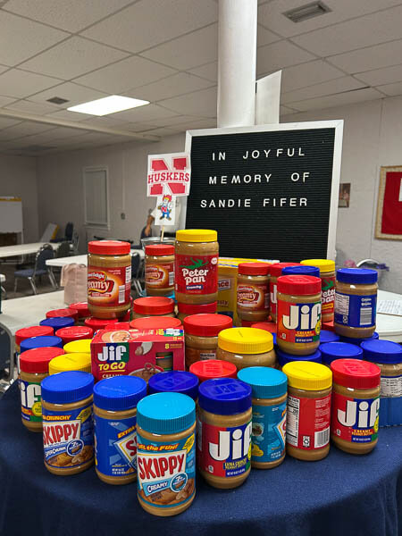Table of peanut butter donations at memorial service