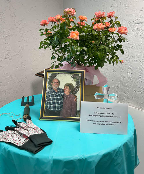 Happy photograph of a couple on a decorated table with a memorial tribute